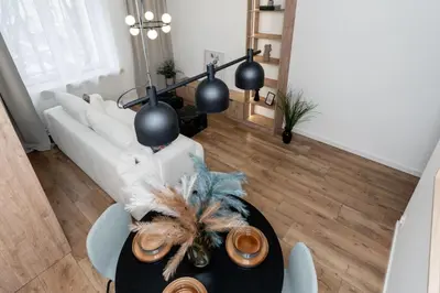 a living room with a table and a white couch at Royal Center Apartments in Kraków