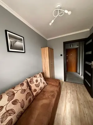 a bedroom with a bed and a flat screen tv at Apartament Center Starowiślna in Kraków