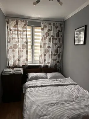 a kitchen with white cabinets and a black stove top oven at Apartament Center Starowiślna in Kraków
