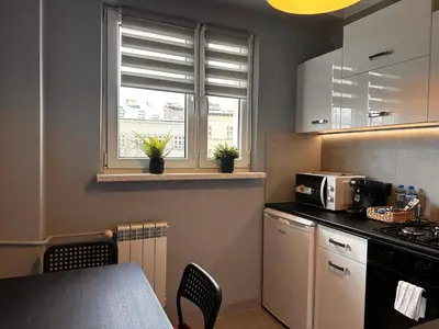 a living room with a couch and a window at Apartament Center Starowiślna in Kraków