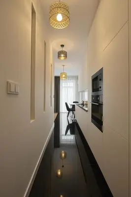 a room with a hallway with a kitchen and a living room at Selected Apartments by market square in Kraków