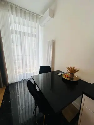 a dining room with a black table and a window at Selected Apartments by market square in Kraków