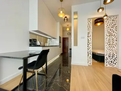 a hallway with a laser cut wood pattern on the wall at Selected Apartments by market square in Kraków
