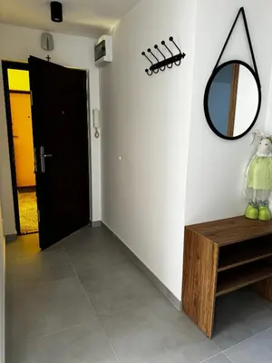 a hallway with a mirror and a wooden table at Apartament na Orkana in Rabka-Zdroj