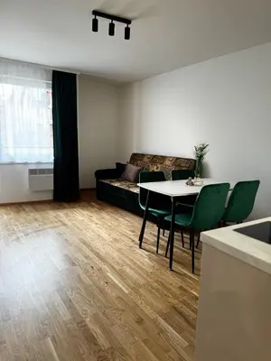 a living room with a table and a couch at Apartament na Orkana in Rabka-Zdroj