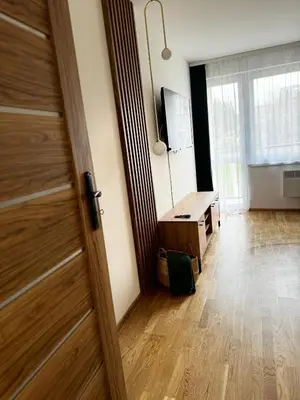 a room with a wooden door and a desk at Apartament na Orkana in Rabka-Zdroj