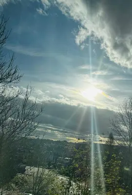 a view of the sun shining through the clouds at Apartament na Orkana in Rabka-Zdroj