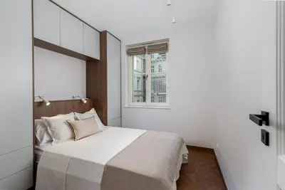 a bedroom with a large bed with a window at San Sebastian - beauty&silence in Kraków
