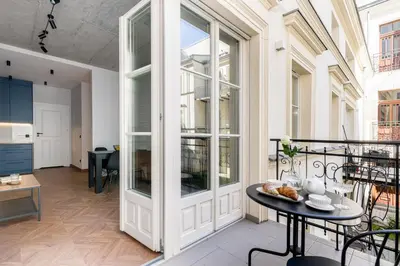 an apartment with a balcony with a table and chairs at San Sebastian - beauty&silence in Kraków
