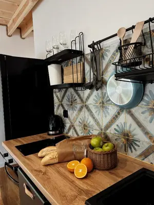 a kitchen counter with a basket of fruit and oranges at Rogaty Domek nad Zalewem in Dobczyce