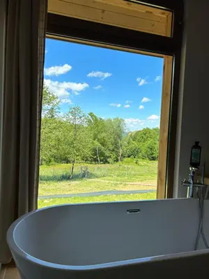 a bath tub sitting in front of a window at Rogaty Domek nad Zalewem in Dobczyce
