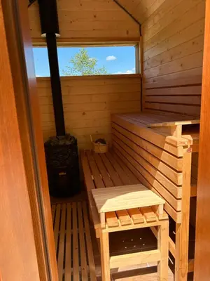 an inside of a sauna with a bench and a stove at Rogaty Domek nad Zalewem in Dobczyce