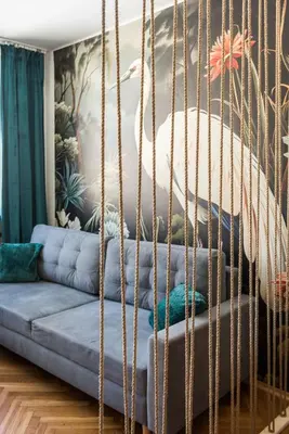 a swinging bed in a living room with a couch at Vistula River Apartment in Kraków
