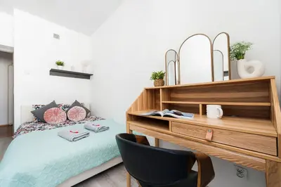 a bedroom with a bed and a desk at Vistula River Apartment in Kraków
