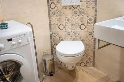 a bathroom with a toilet and a sink at Grzegórzki Studio - Main Station & Parks nearby - by Rentujemy in Kraków