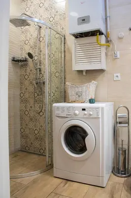 a washing machine in a bathroom with a shower at Grzegórzki Studio - Main Station & Parks nearby - by Rentujemy in Kraków