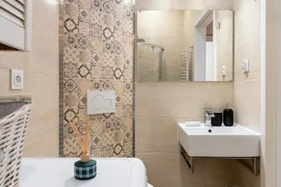 a bathroom with a white sink and a mirror at Grzegórzki Studio - Main Station & Parks nearby - by Rentujemy in Kraków