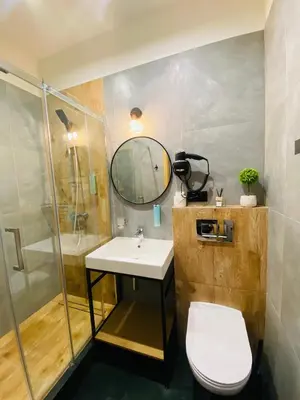 a bathroom with a sink and a shower and a toilet at Krakow Apartments & Rooms in Kraków