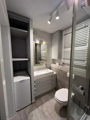 a bathroom with a toilet and a sink at Angel City Apartament in Kraków