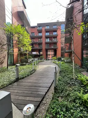 a wooden walkway in front of a building at Angel City Apartament in Kraków