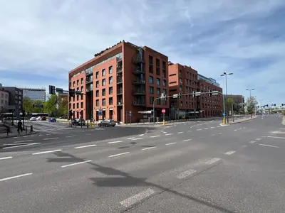 an empty city street with buildings and a traffic light at Angel City Apartament in Kraków