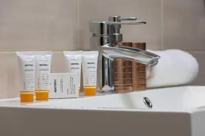 a bathroom sink with a faucet and toothbrushes at Podgórze Air-Conditioned Family Apartment with Parking by Noclegi Renters in Kraków