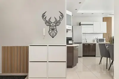 a kitchen with a deer head on the wall at Podgórze Air-Conditioned Family Apartment with Parking by Noclegi Renters in Kraków