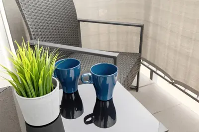 three blue vases sitting on a table with plants at Podgórze Air-Conditioned Family Apartment with Parking by Noclegi Renters in Kraków