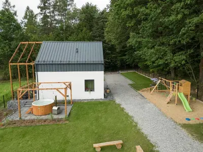 an overhead view of a small cabin in a field with trees at Okno na Beskidy in Maków Podhalański