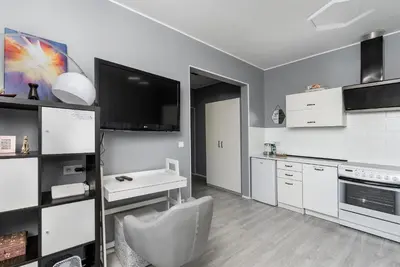 a kitchen with a couch and a table in a room at Cegielniana Grey Studio by BookingHost in Kraków
