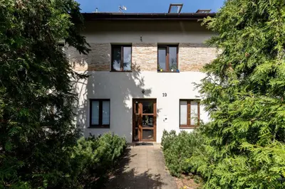 a kitchen with white cabinets and a blue couch at Cegielniana Grey Studio by BookingHost in Kraków