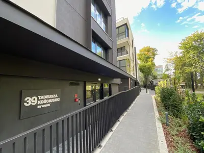 a building with a sign on the side of it at Vistula Avenue Apartment free Parking in Kraków