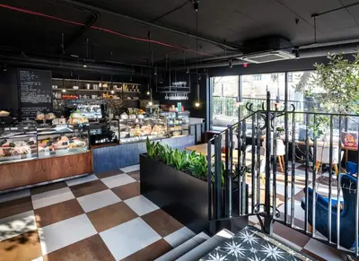 a restaurant with a counter with a bakery at Vistula Avenue Apartment free Parking in Kraków
