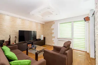a living room with a couch and a tv at Prokocim Podłęska Studio by BookingHost in Kraków