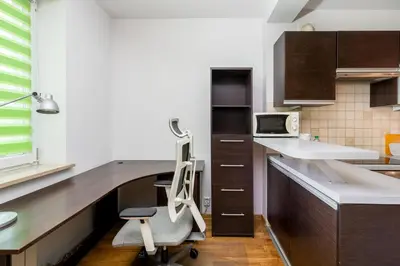 a kitchen with a desk with a chair in it at Prokocim Podłęska Studio by BookingHost in Kraków