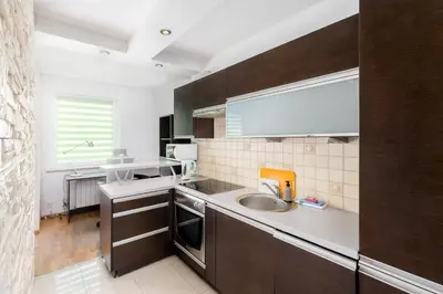 a kitchen with a sink and a counter top at Prokocim Podłęska Studio by BookingHost in Kraków