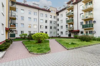 a courtyard in a building with a pathway and buildings at Prokocim Podłęska Studio by BookingHost in Kraków