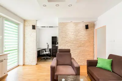 a living room with a couch and a chair at Prokocim Podłęska Studio by BookingHost in Kraków