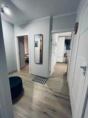 an empty room with a mirror and a hallway at MR HOME APARTMENTS - Mogilska in Kraków