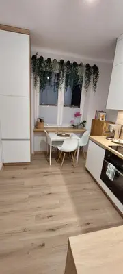 a kitchen with a table and chairs in a kitchen at MR HOME APARTMENTS - Mogilska in Kraków