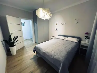 a bedroom with a bed and a potted plant at MR HOME APARTMENTS - Mogilska in Kraków
