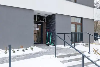 a door to a building with a snowboard outside at Luxury Apartment near the City Center of Cracow by Renters Prestige in Kraków