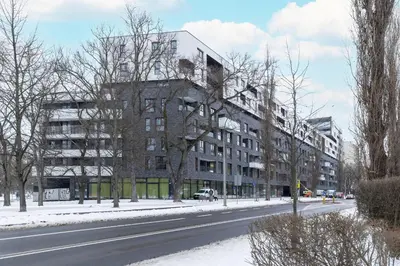 an apartment building on the side of a snowy street at Luxury Apartment near the City Center of Cracow by Renters Prestige in Kraków