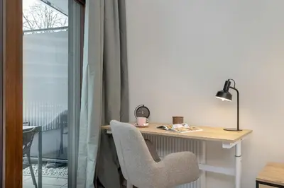 a desk with a chair next to a window at Luxury Apartment near the City Center of Cracow by Renters Prestige in Kraków