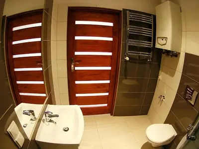 a bathroom with a sink and a toilet and a shower at VisitKrak in Kraków