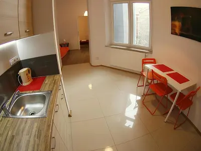 a kitchen with a sink and a table at VisitKrak in Kraków