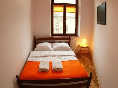 a bedroom with a bed with two towels on it at VisitKrak in Kraków