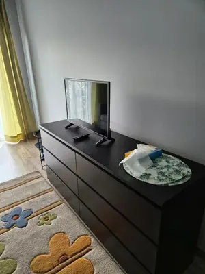 a dresser with a mirror on top of it at Apartament Bunsha Kraków in Kraków