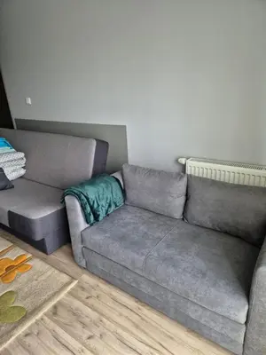 a living room with a gray couch at Apartament Bunsha Kraków in Kraków
