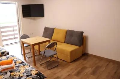a living room with a couch and a table at Apartamenty Zator Energy Rest in Zator
